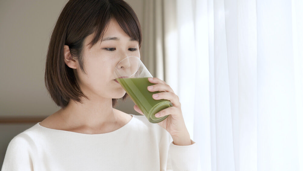 Woman drinking Japanese healthy drink, green juice