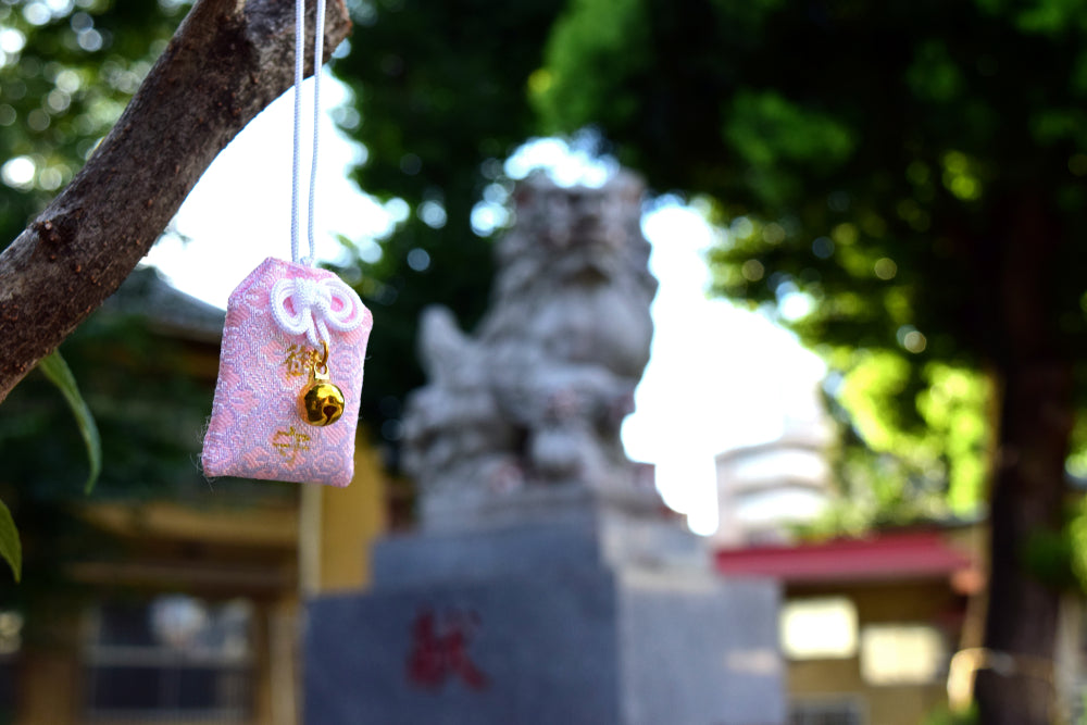 A charm and scenery of Japanese shrine. Japanese kanji appear in an image are "Omamori", that mean "lucky charm".