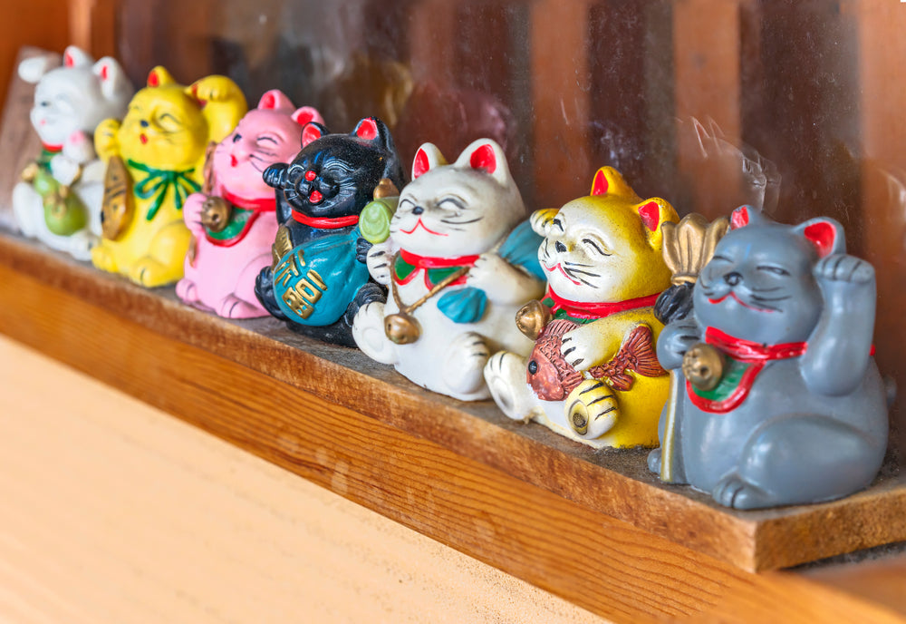 Manekineko lucky cats depicting the seven gods of happiness Bishamonten, Ebisu, Daikokuten, Hotei, Jurojin, Benzaiten and Fukurokuju in the shopping street Yanaka Ginza.