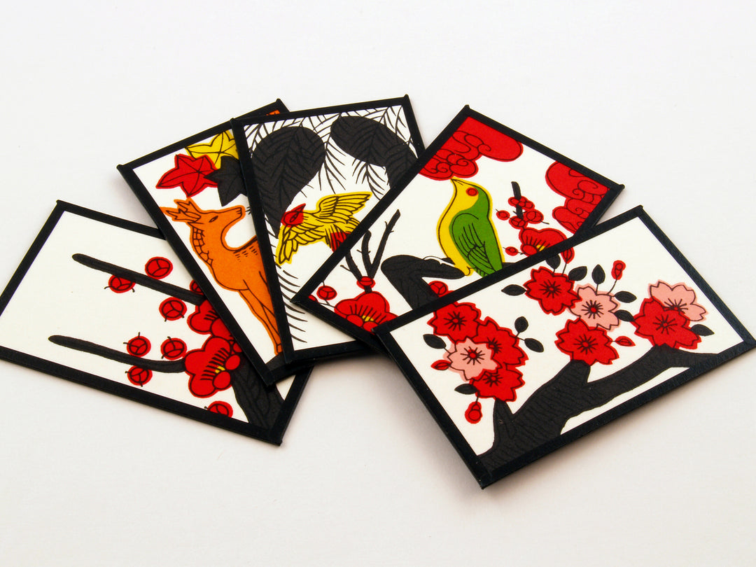 Five Japanese hanafuda cards laying flat on a table