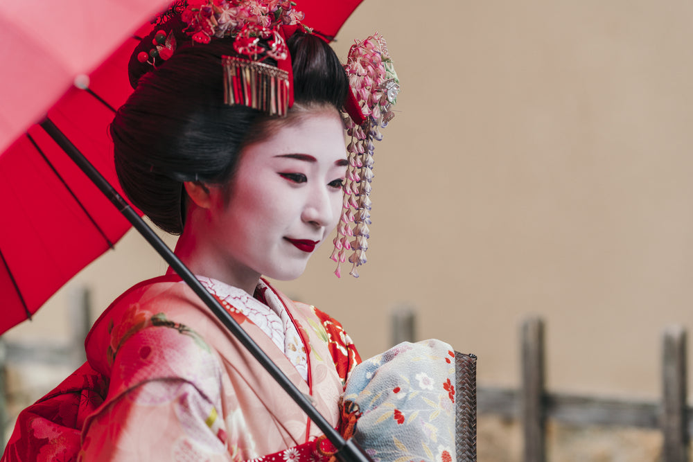 A geisha holding a parasol.